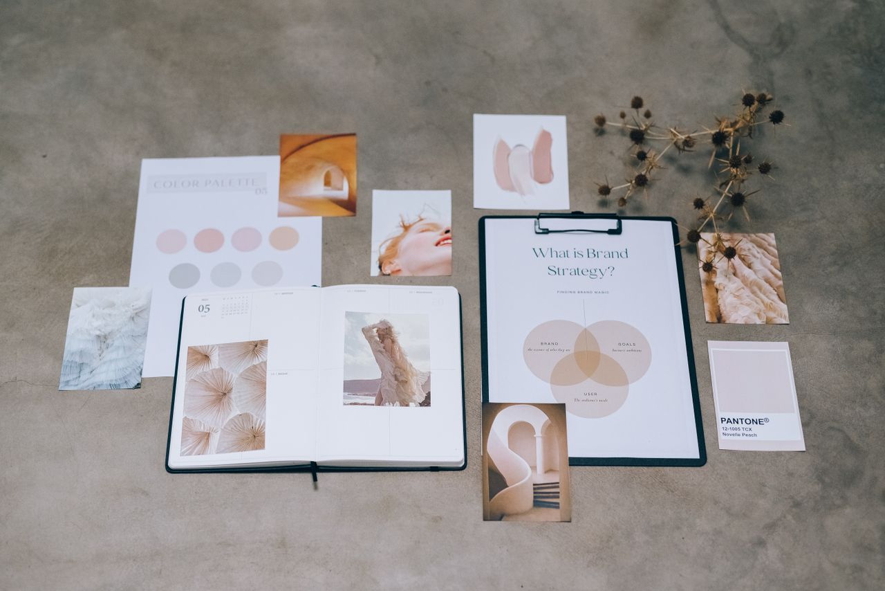 services-04 A flat lay of branding elements with color palettes and strategic planning documents on a concrete surface.